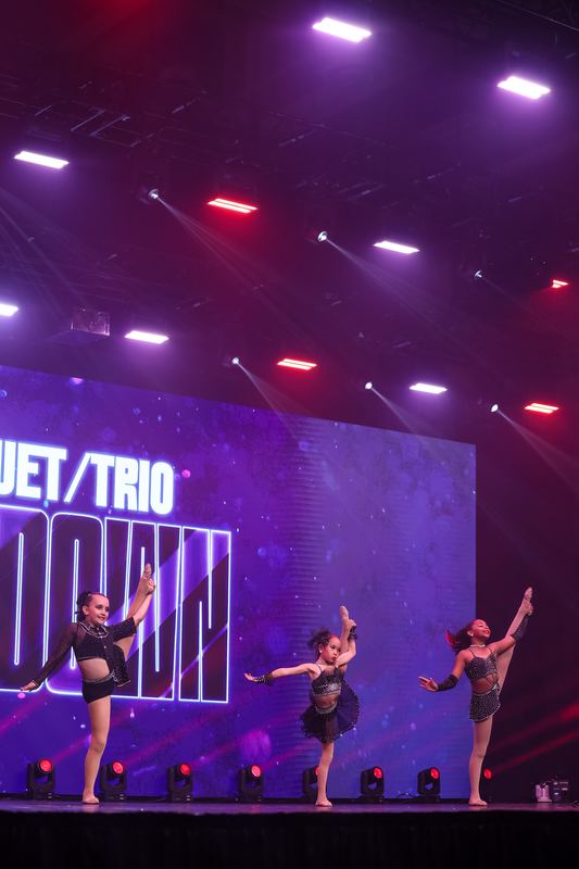 Dancers performing in front of the Duet/Trio Showdown screen